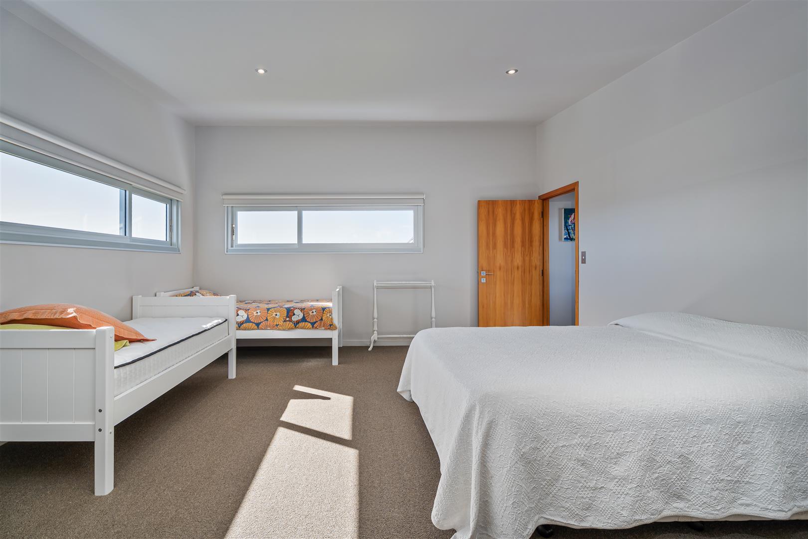 Spacious bedroom with a double bed and two single beds